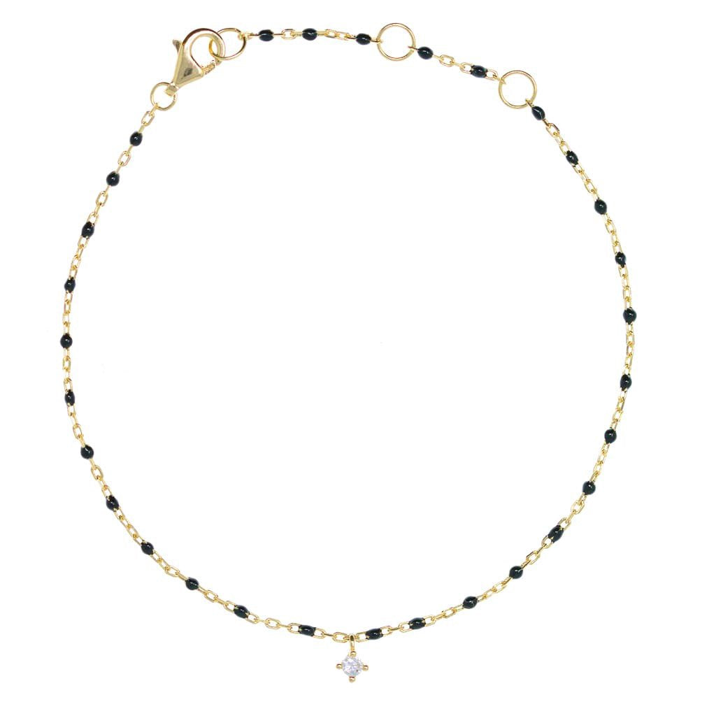 Gold chain and black bead bracelet with hanging CZ.