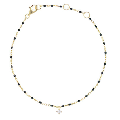 Gold chain and black bead bracelet with hanging CZ.