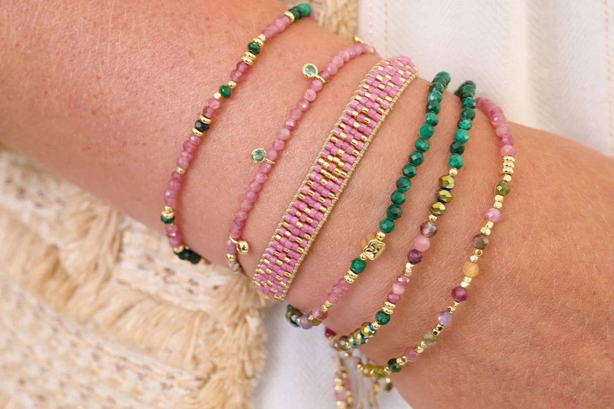 Holly Gold & Pink Tourmaline Beaded Charm Bracelet  stacked with other bracelets from the collection 