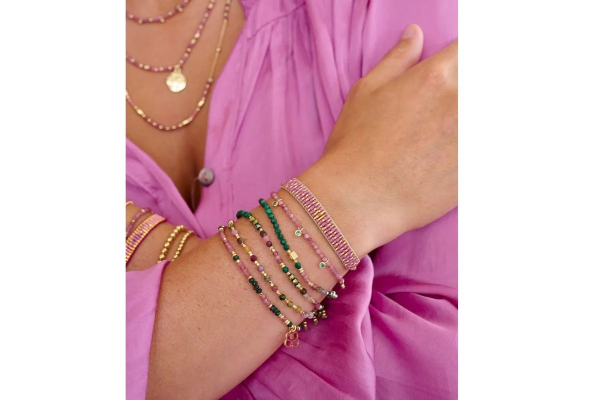 Dash Malachite & Pink Tourmaline Bead Bracelet worn with other bracelets in the collection 