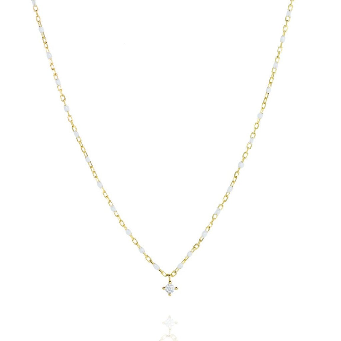 Short gold chain and bead necklace. White bead, small cubic zirconia at a central point on the necklace.